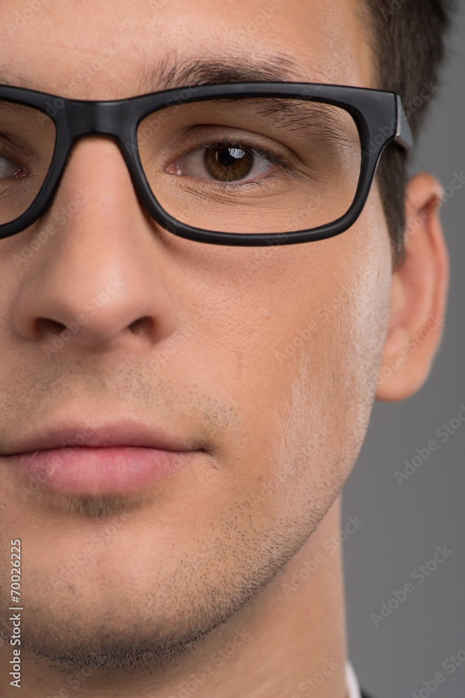 Portrait of half face of man looking at camera. Portrait of half face of man looking at camera.