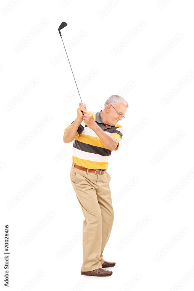 Profile shot of a senior swinging a golf club