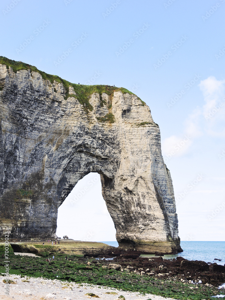 rock with arch on english channel beach