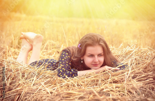 beautiful young brunette girl on the meadow