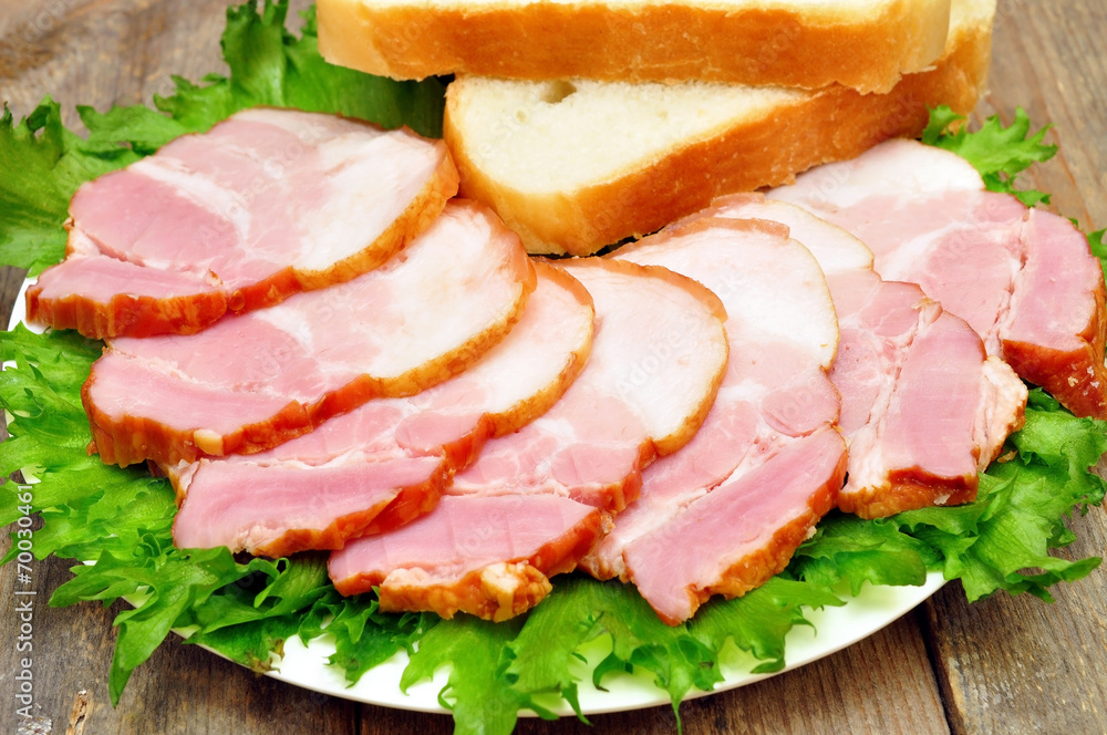 sliced bacon on a plate with bread sliced bacon on a plate with bread