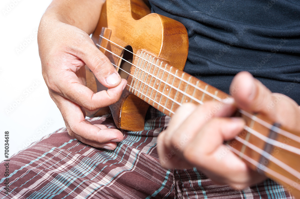 Fototapeta premium Hand playing ukulele, small string instrument