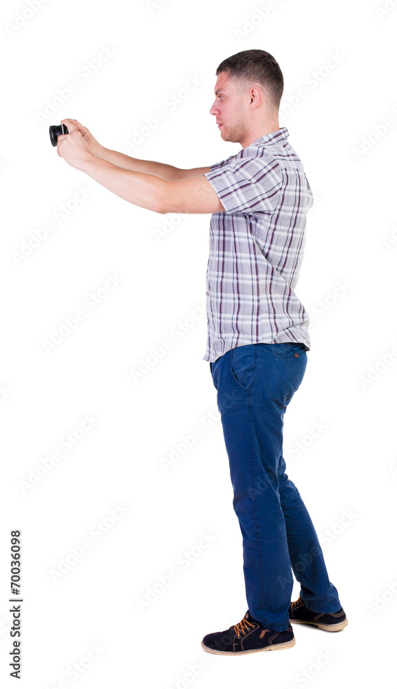 Back view of man photographing. tourist with camera. Back view of man photographing. tourist with camera.