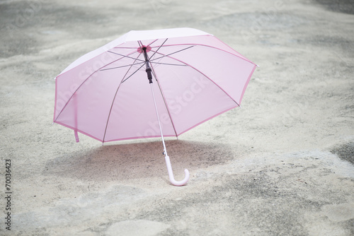 Pink umbrella outdoor on concrete floor in sunlight. © isuaneye