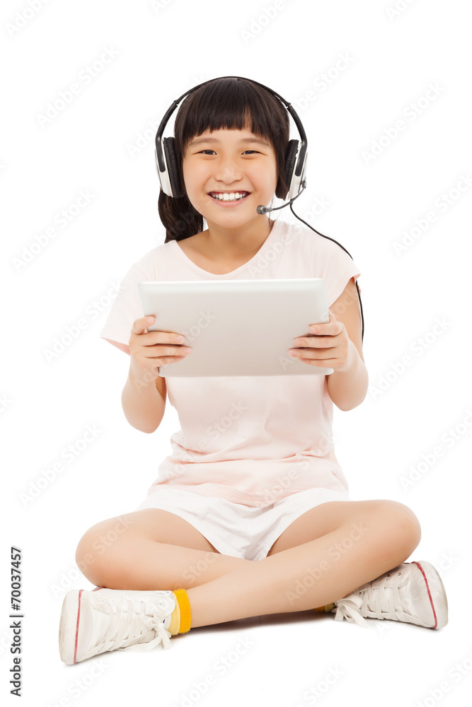 sitting little girl holding a tablet with earphone sitting little girl holding a tablet with earphone