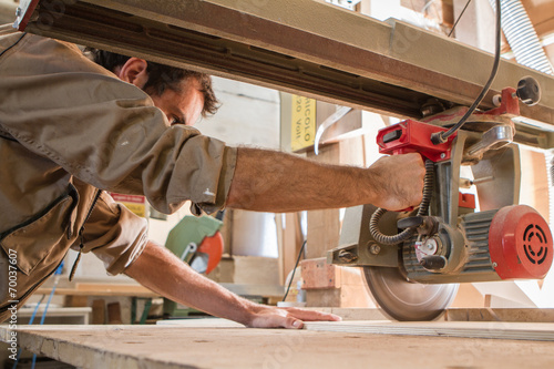 young carpenter work with circular saw