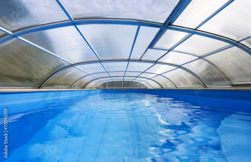 Outdoor swimming pool with a shelter