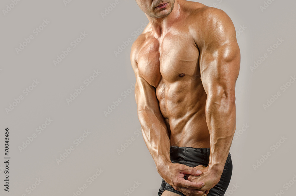 Fototapeta premium Strong bodybuilder with perfect abs, shoulders,biceps, triceps