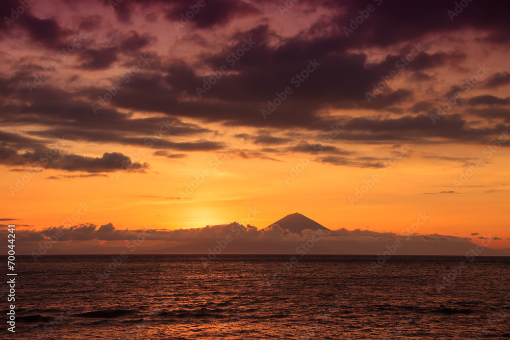 Amazing sunset featuring volcano and sea