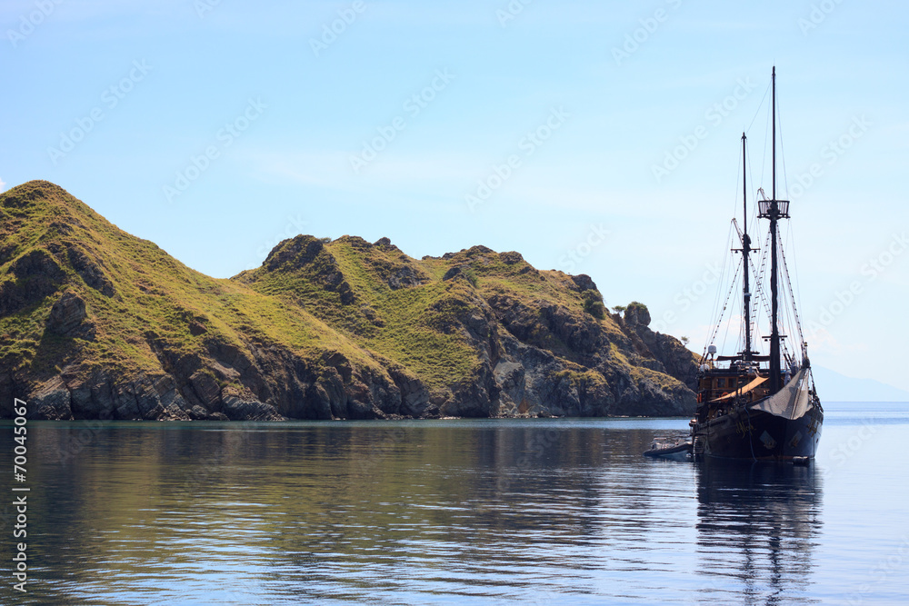 Pirat ship next to island in sea 