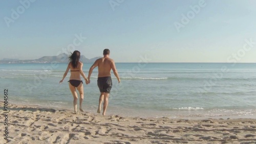 young couple having fun at the beach. majorca, spain.