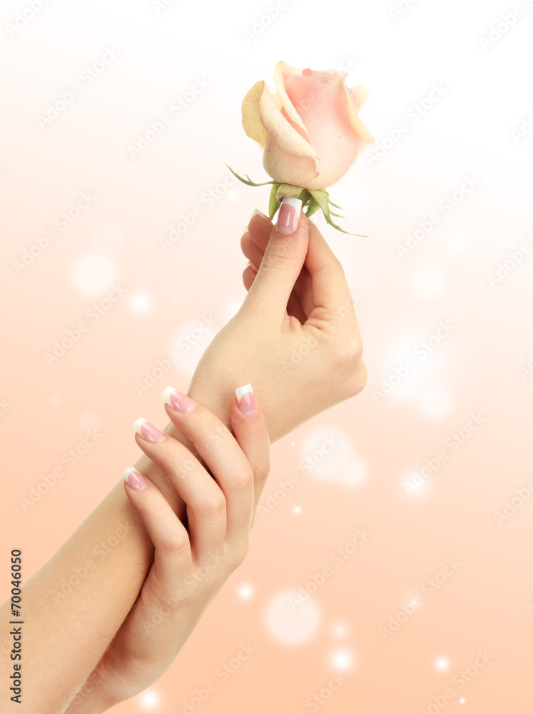 Young woman hands with elegance manicure on bright background Young woman hands with elegance manicure on bright background