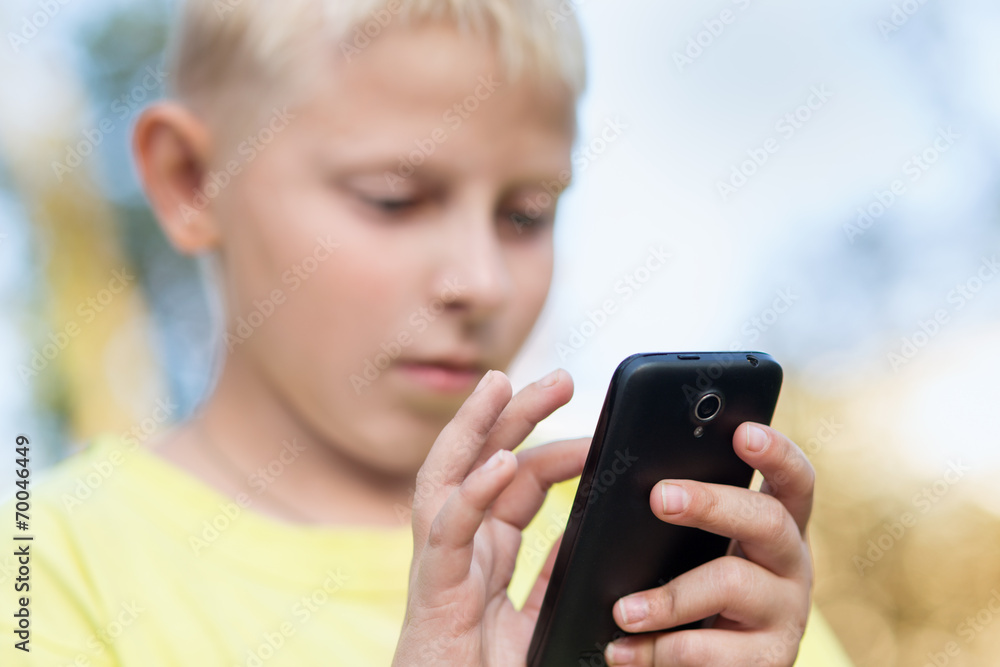 Fototapeta premium child playing on your smartphone