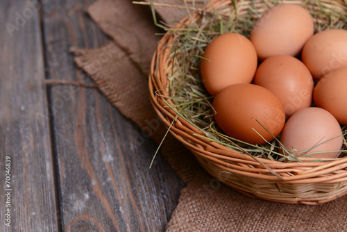 Eggs in wicker basket on table close-up