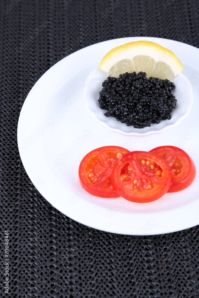 Black caviar with slices of tomato Black caviar with slices of tomato
