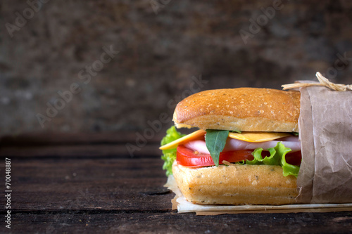 Sandwich on wooden background photo