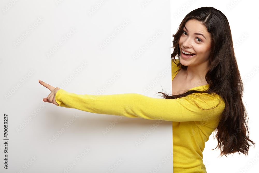 young woman pointing her finger at blank board young woman pointing her finger at blank board