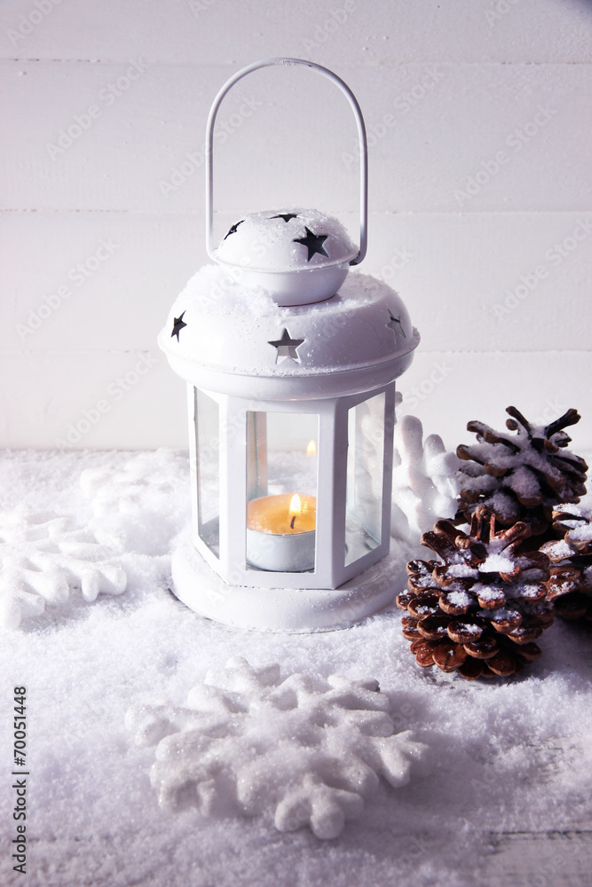 White flash light and Christmas decoration on light background