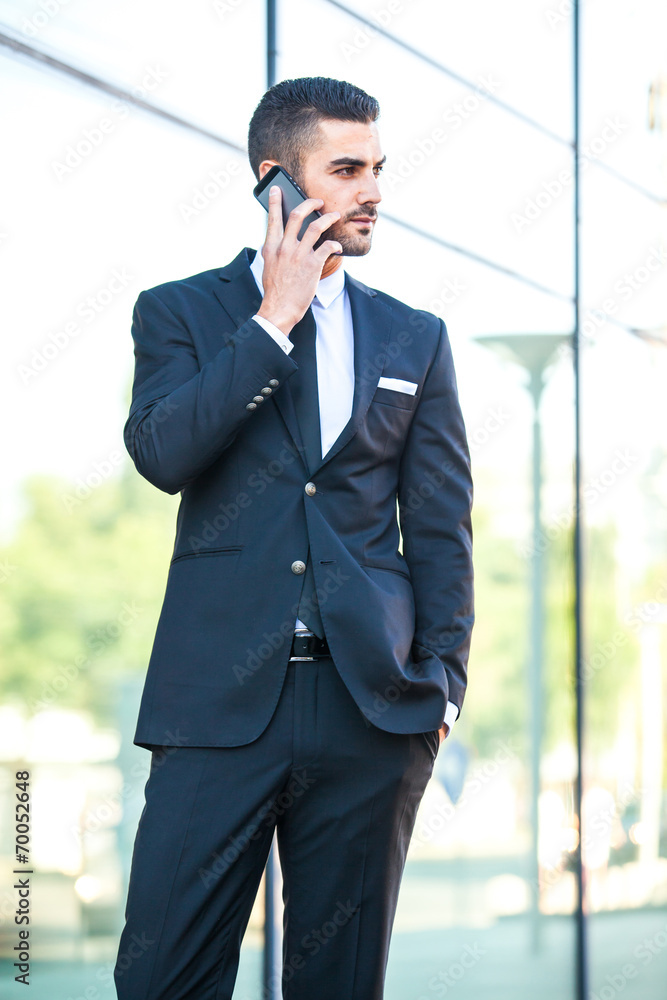elegant man talking at cellphone on the street elegant man talking at cellphone on the street