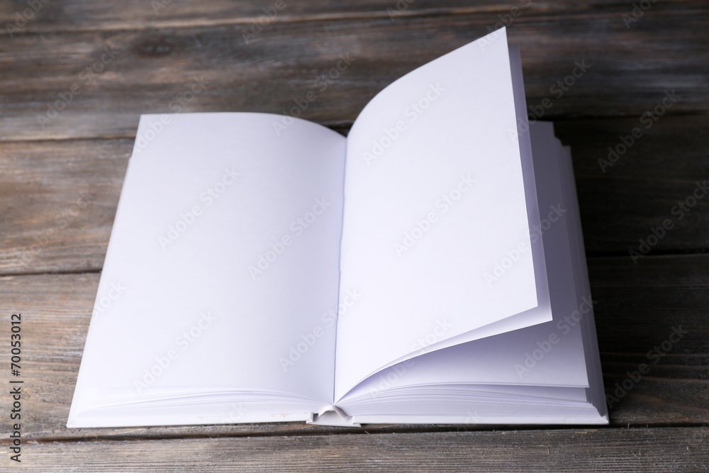 White book on wooden table, close-up White book on wooden table, close-up
