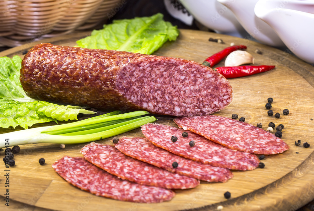 sausages on a wooden plate with vegetables in a restaurant