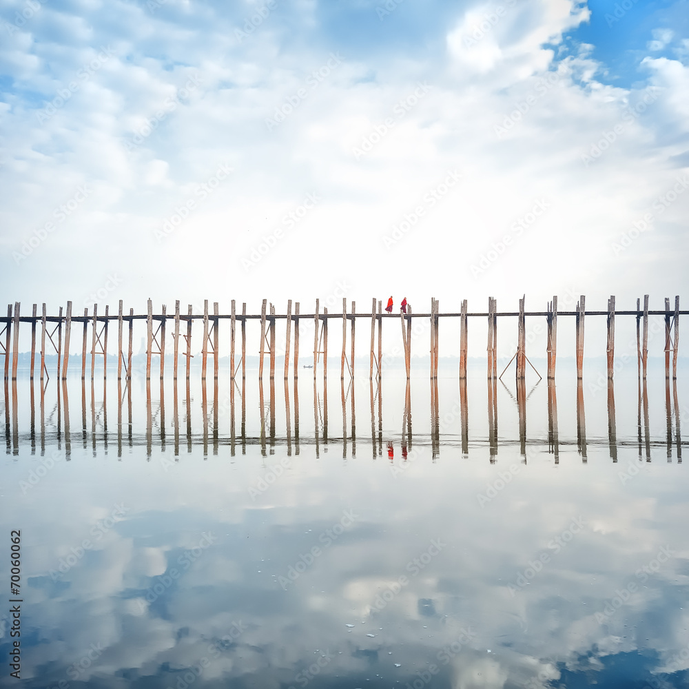 Buddhist monks crossing wooden U Bein bridge in Myanmar Buddhist monks crossing wooden U Bein bridge in Myanmar
