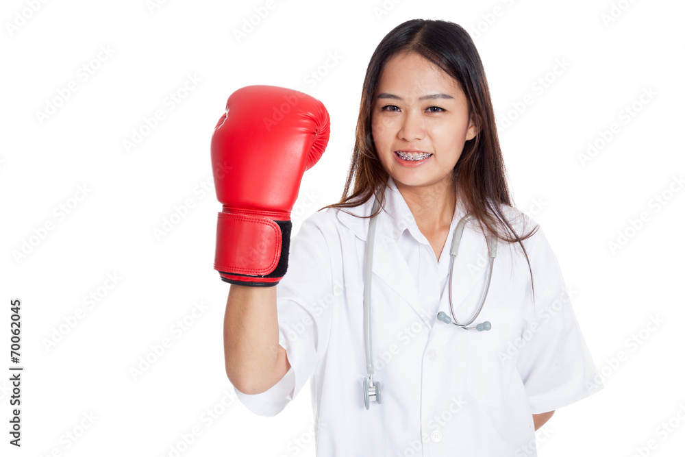 Young Asian female doctor with boxing glove Young Asian female doctor with boxing glove