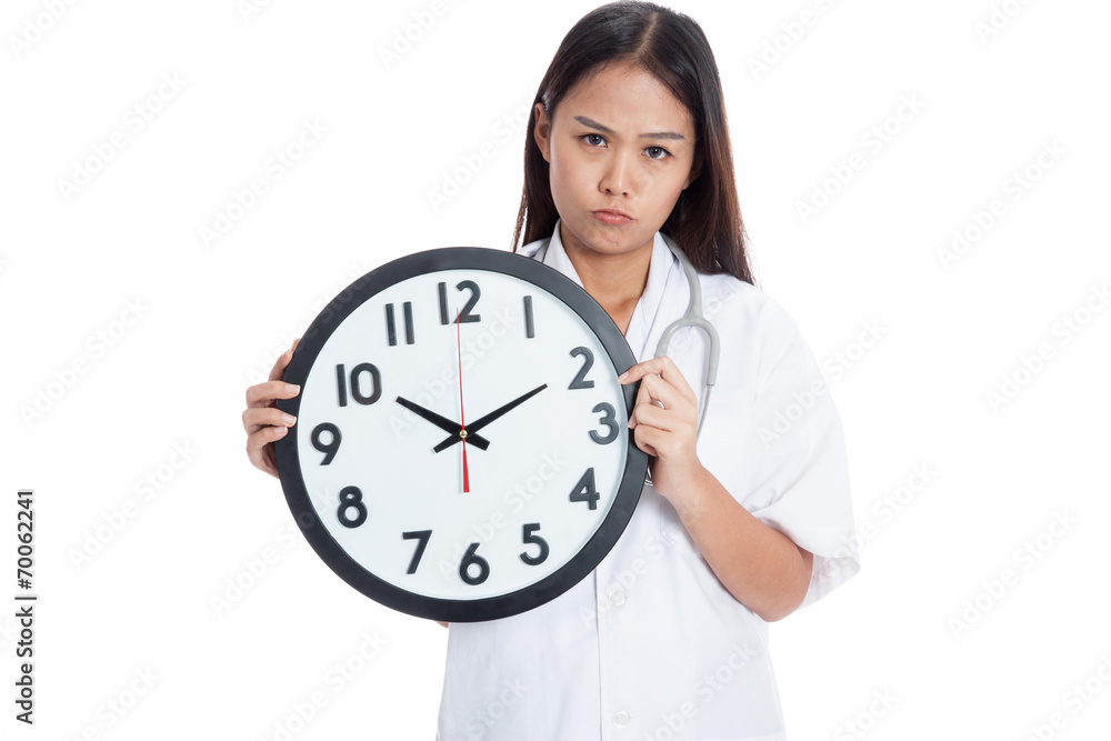 Frustrated Young Asian female doctor with a clock Frustrated Young Asian female doctor with a clock