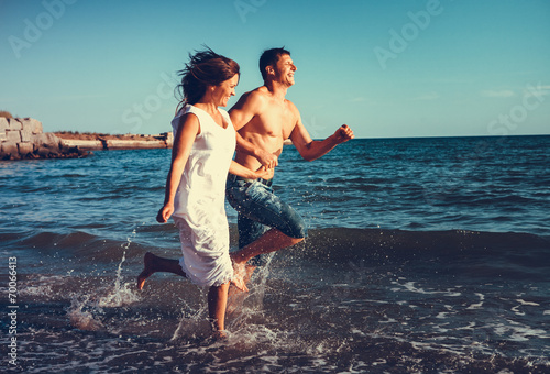 Romantic couple having fun on the beach © liandstudio
