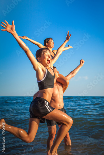 Family of four having fun at the beach