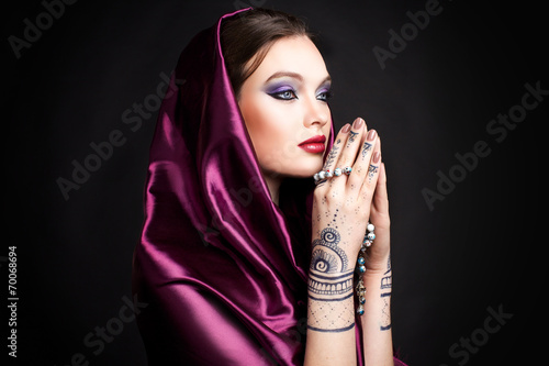 beautiful woman in oriental style with mehendi