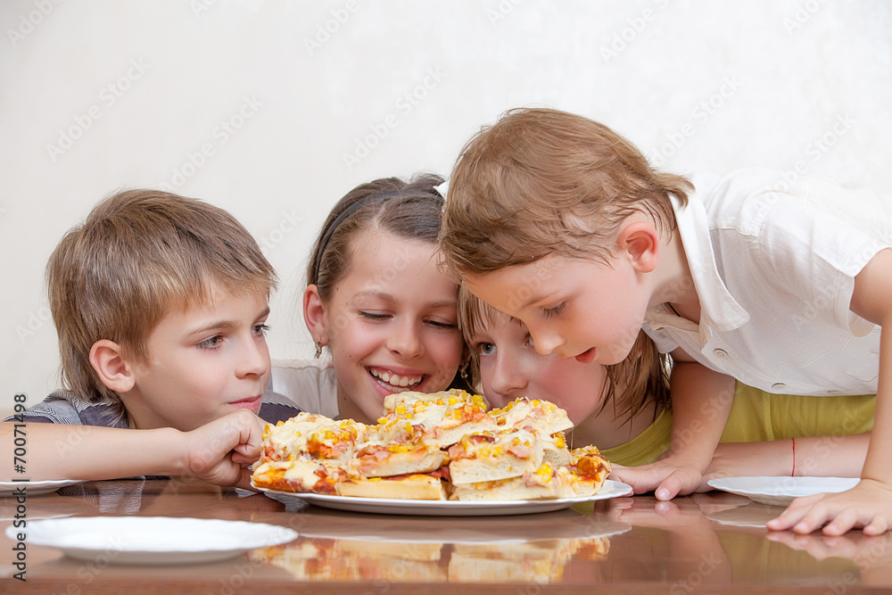 Happy group of kids eating pizza and smiling Happy group of kids eating pizza and smiling