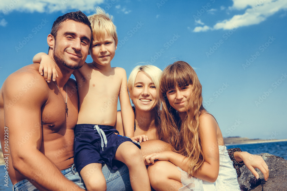 family on the stone coast near the sea family on the stone coast near the sea