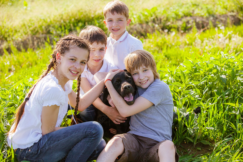 dog smiling with three young kids