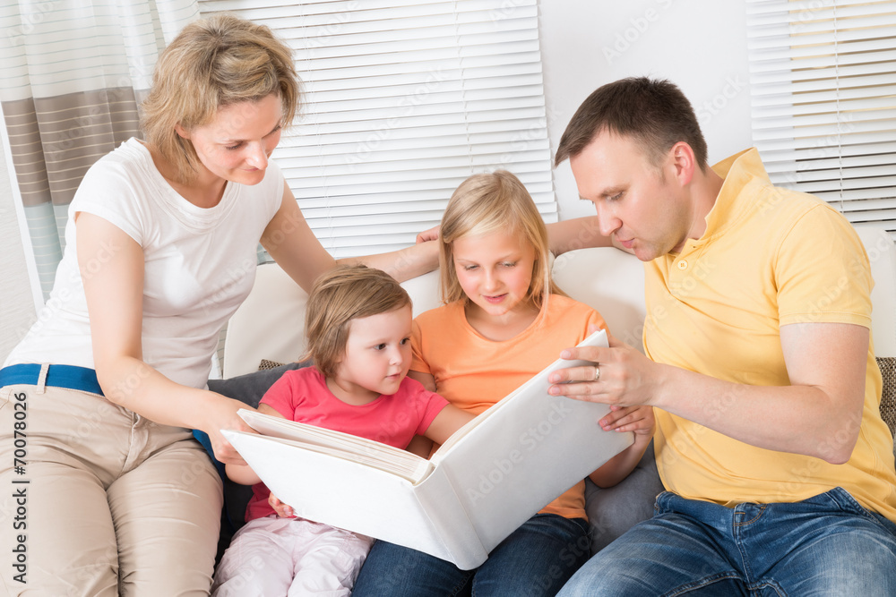 Family Looking At Photos In Photobook Family Looking At Photos In Photobook