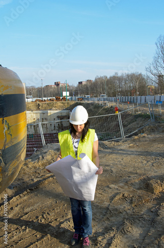 Young female architect at the construction site of the construct