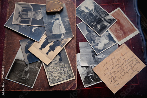 Old photos and letter on brown background.