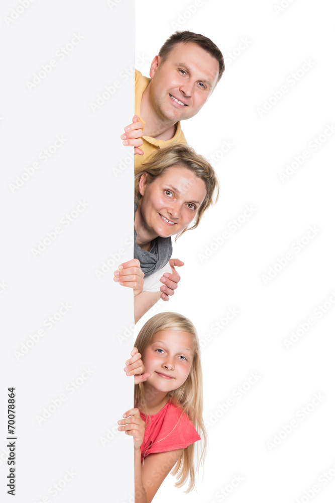 Happy Young Family Holding Banner Happy Young Family Holding Banner