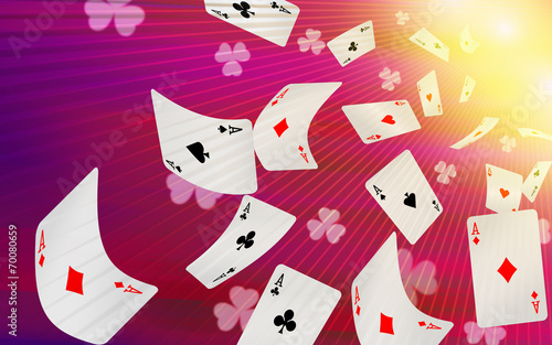 Playing cards falling on a pink background