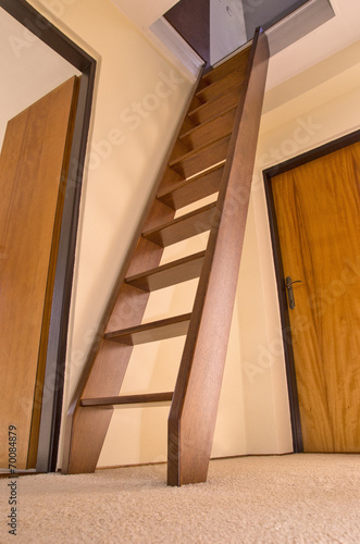Wooden staircase to the attic