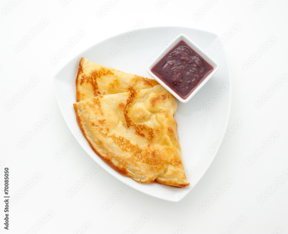 Pancake with strawberry jam on a white plate Pancake with strawberry jam on a white plate