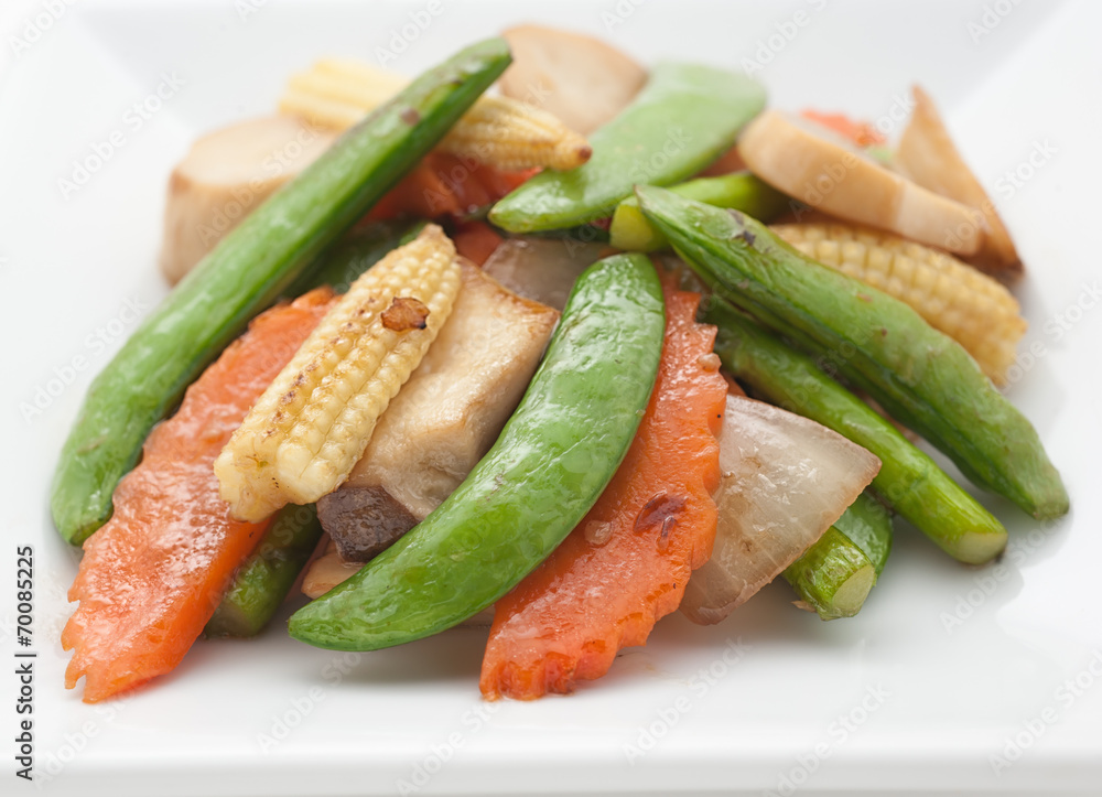 Fried mixed vegetables and pork on white plate