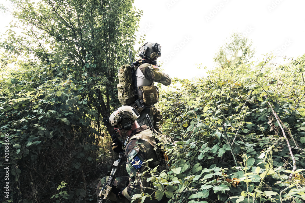 Soldiers in uniform of the U.S. Army in the woods
