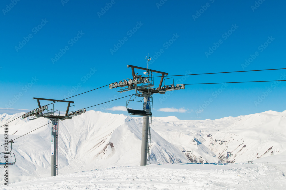 Obraz premium Skilift on ski resort during winter on bright day