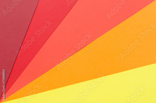 warm-colored construction paper sheets arranged diagonally