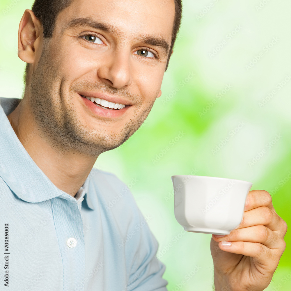 Happy smiling man drinking coffee, outdoors Happy smiling man drinking coffee, outdoors