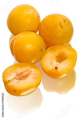 Yellow plums on white