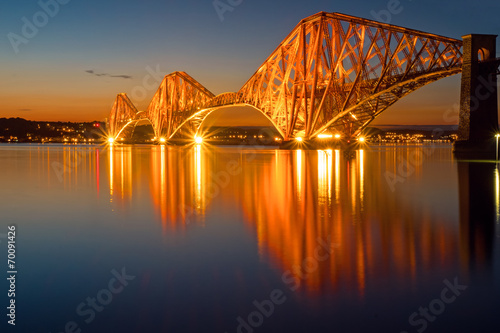 The illuminated Forth rail bridge in Scotland