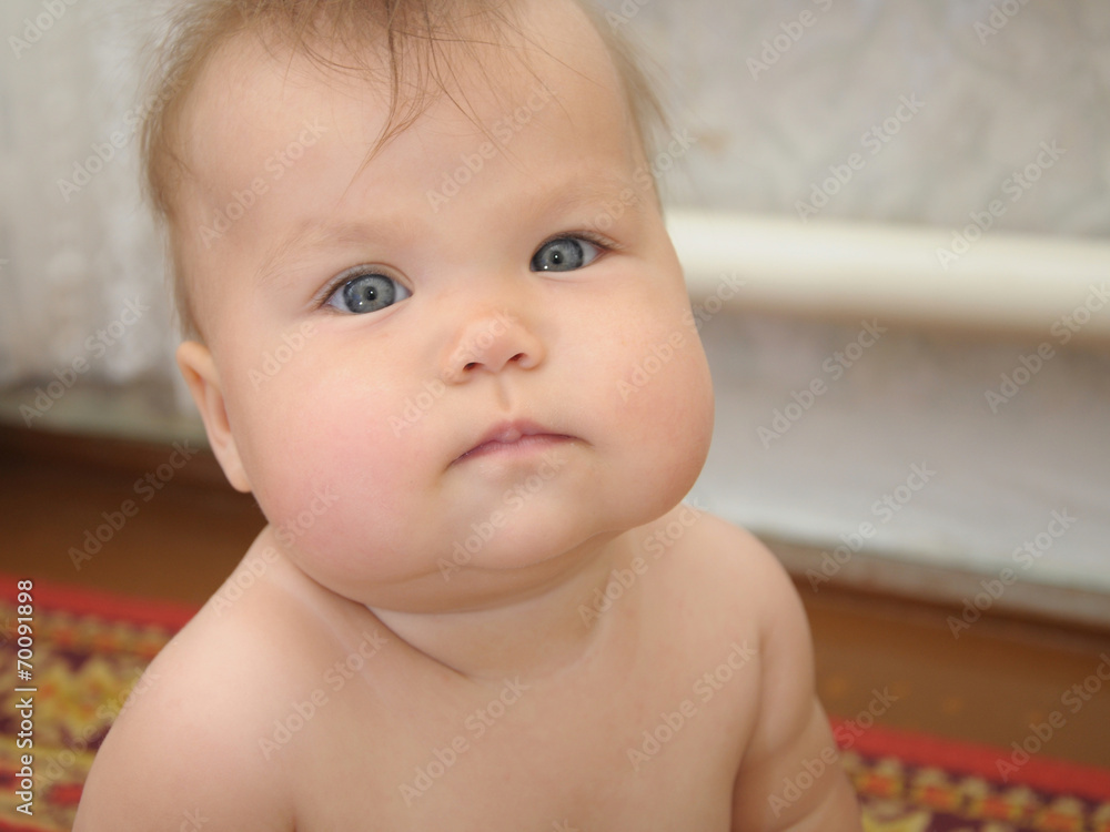 Adorable Baby child with chubby cheeks looking Adorable Baby child with chubby cheeks looking