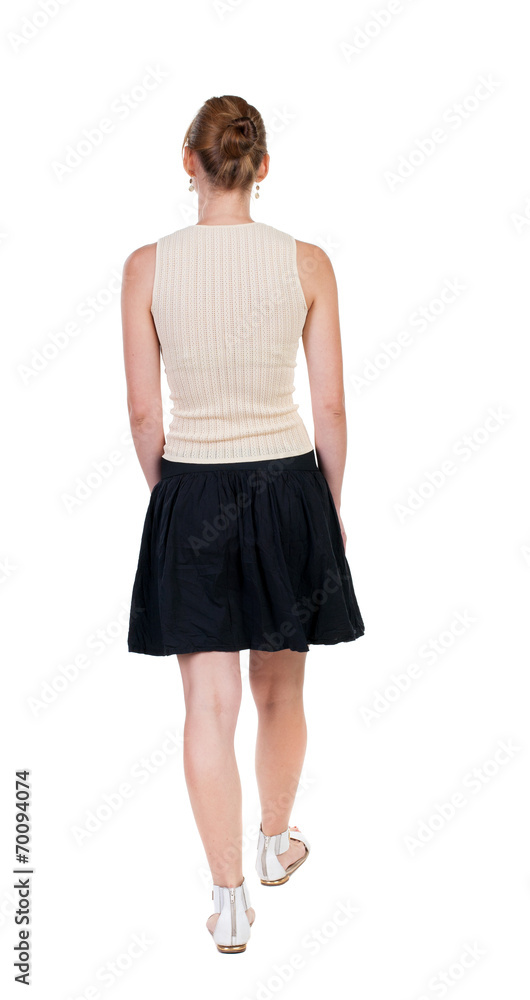 back view of walking woman in dress. beautiful blonde girl in m back view of walking woman in dress. beautiful blonde girl in m